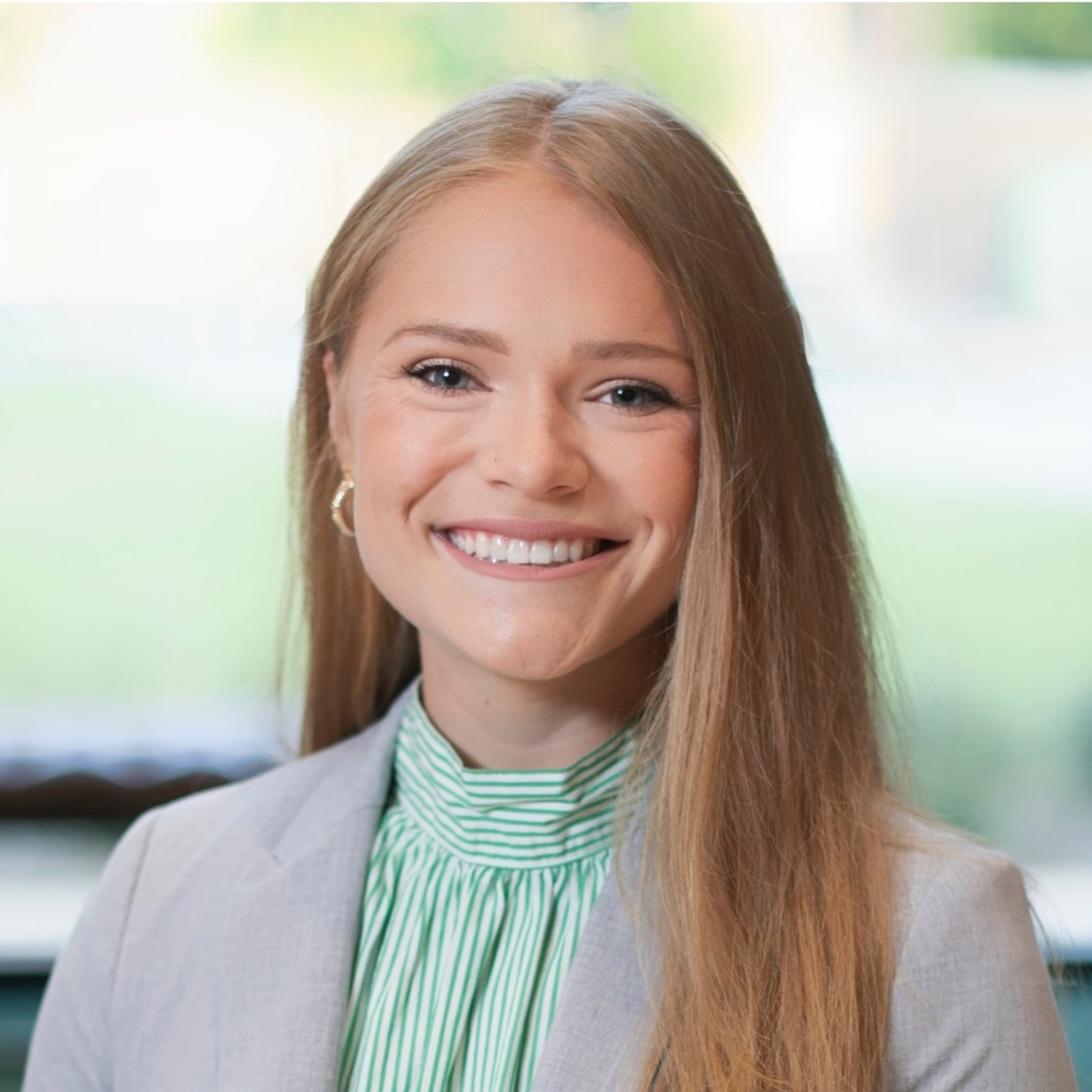 Woman wearing a blazer, smiling